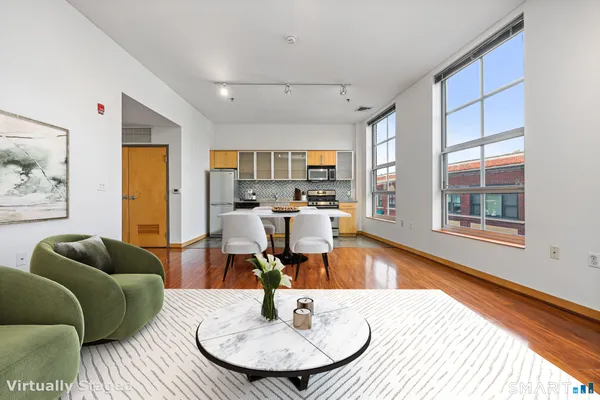 a living room with furniture and a wooden floor