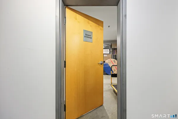 a view of a hallway with wooden floor and a living room