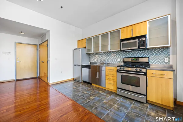a kitchen with stainless steel appliances granite countertop a stove and a sink