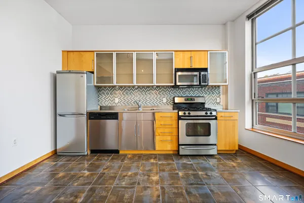 a kitchen with a stove and a refrigerator
