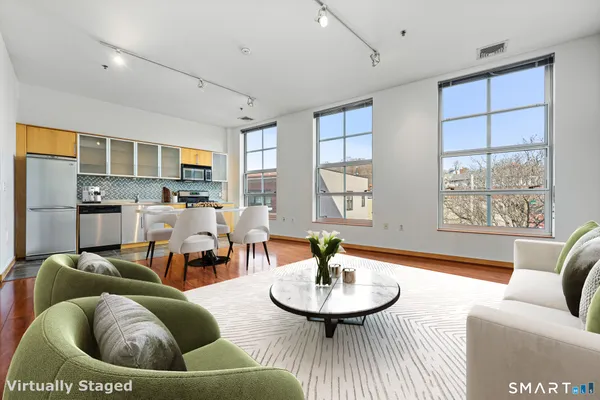 a living room with furniture and a wooden floor