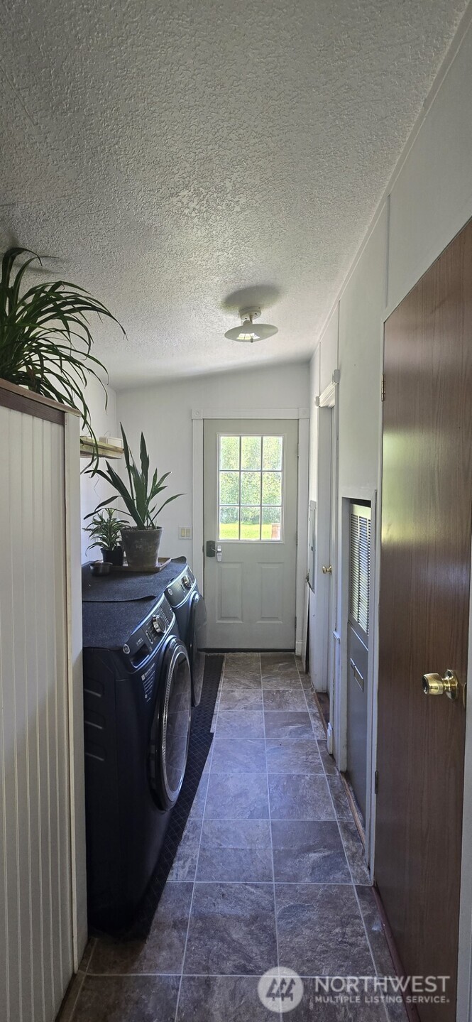 123 Barton Road Rochester, WA 98579 - Photo 21 of 25 a view of a hallway with washer and dryer