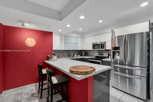 a kitchen with a refrigerator a stove a sink and a refrigerator