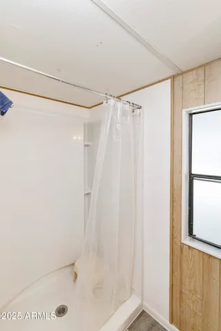 a bathroom with a shower and a glass door