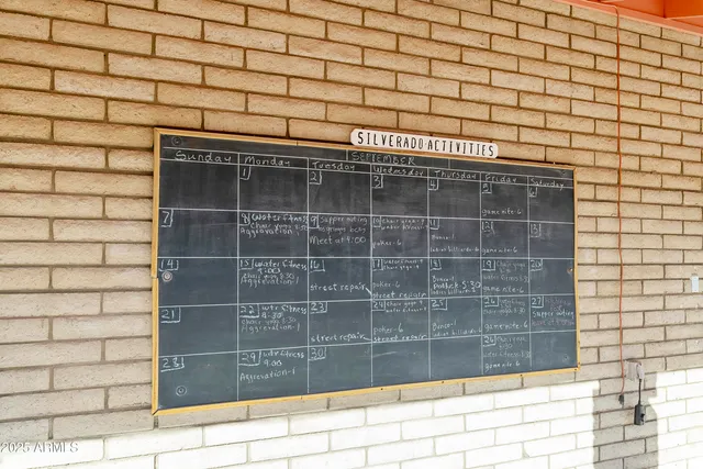 a room with pool table and windows