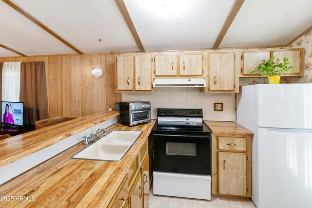 a kitchen with a stove a sink and a refrigerator
