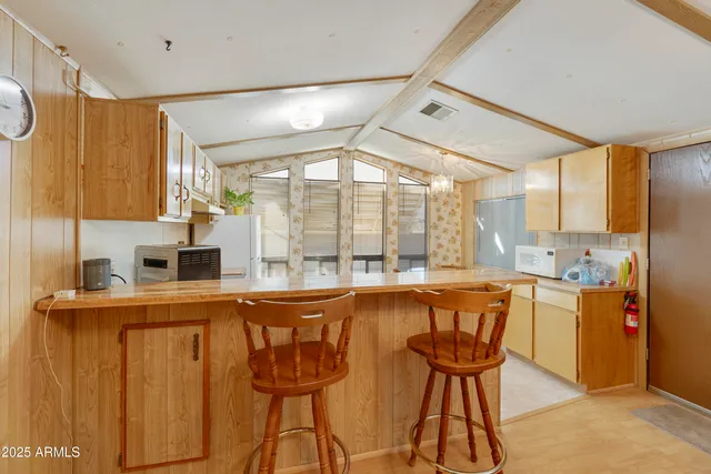 a kitchen that has a cabinets and a table in it