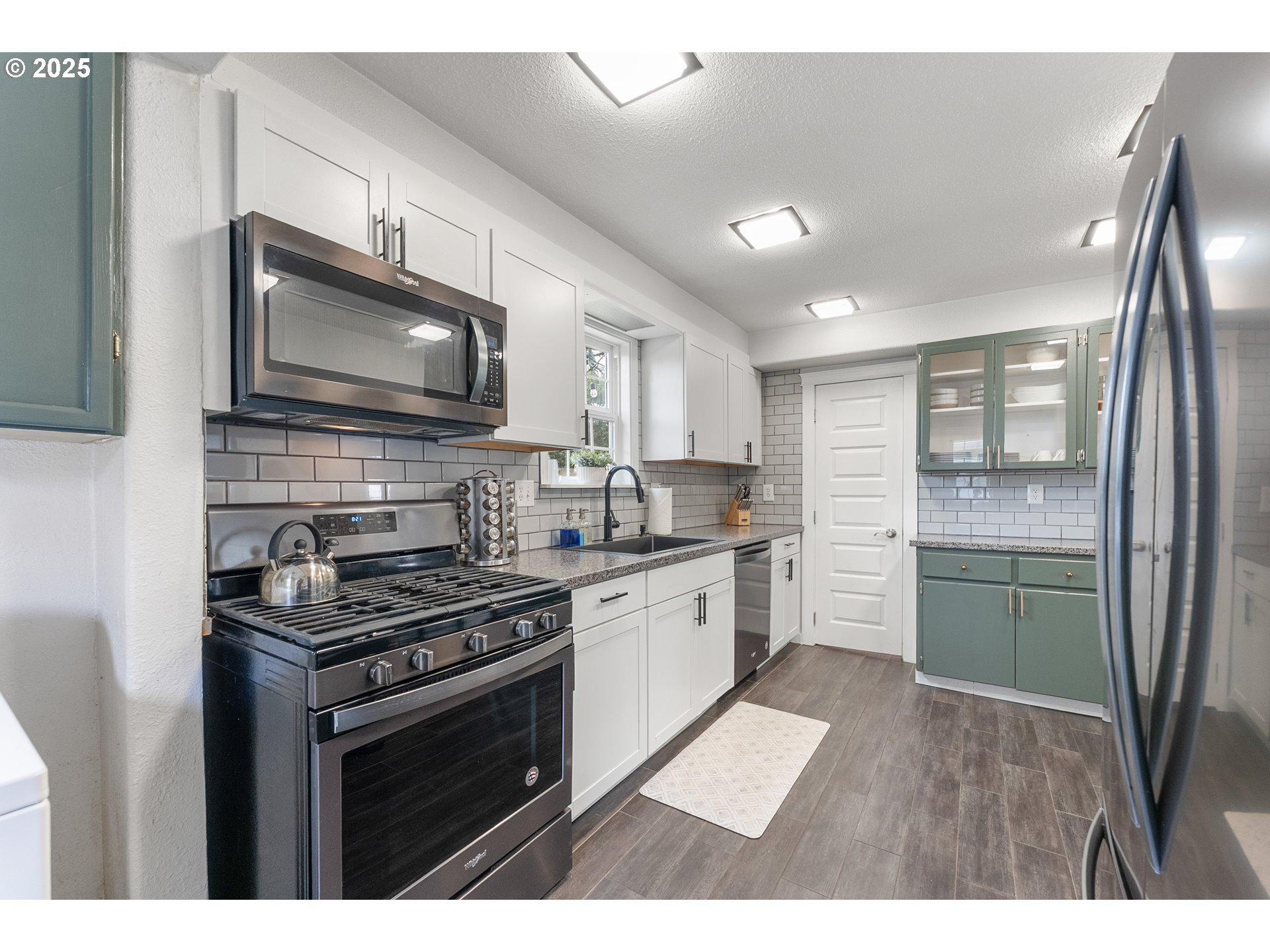 523 West Broccoli Street Roseburg, OR 97471 - Photo 14 of 43 a kitchen with stainless steel appliances kitchen island granite countertop a stove refrigerator and a microwave