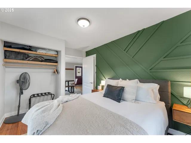 a bedroom with a bed and a mirror