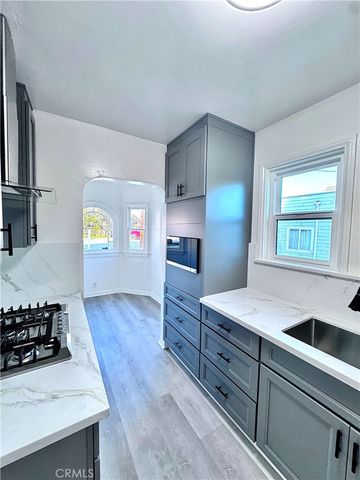 a kitchen with granite countertop a sink and a stove top oven