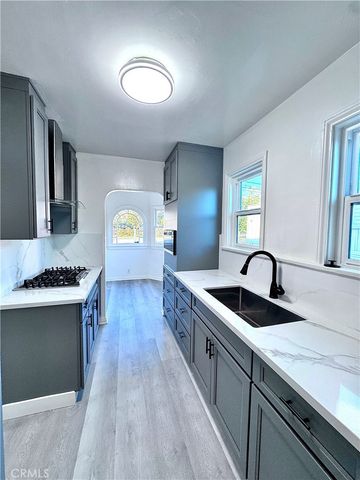 a kitchen with stainless steel appliances granite countertop a sink stove and cabinets