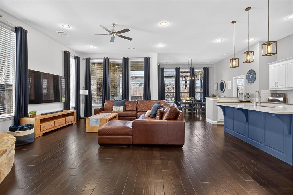 1010 Longhill Way Forney, TX 75126 - Photo 16 of 38 a living room with furniture kitchen view and a flat screen tv