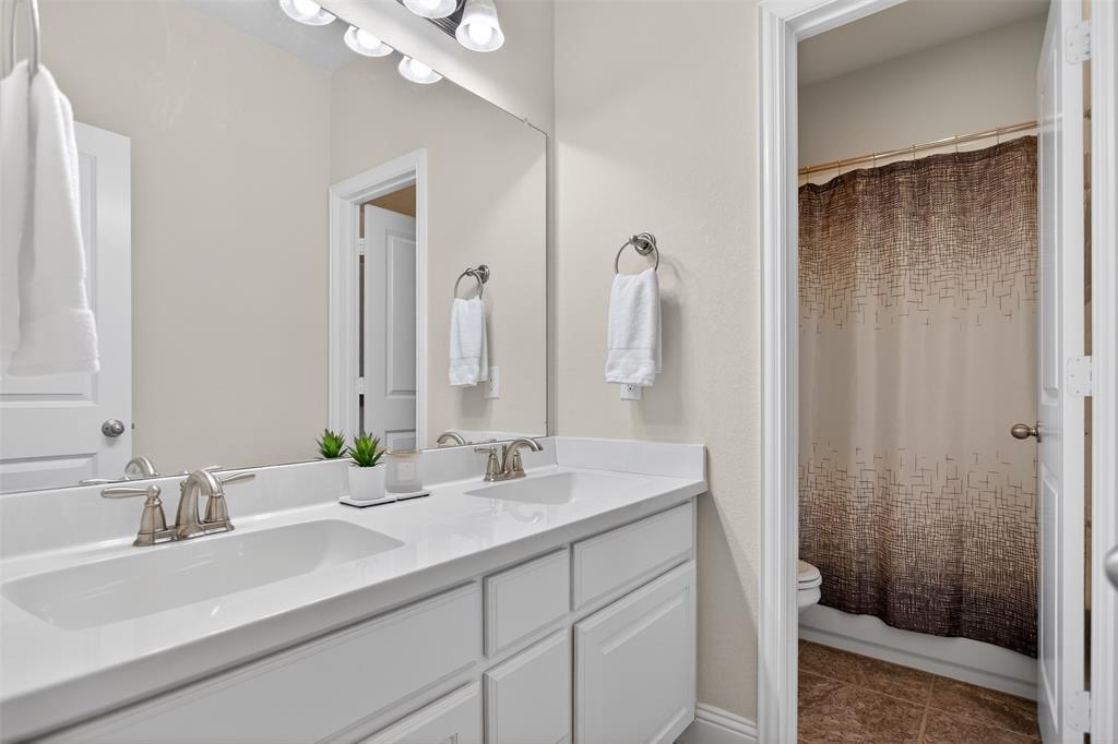 1010 Longhill Way Forney, TX 75126 - Photo 21 of 38 a bathroom with a double vanity sink mirror and shower