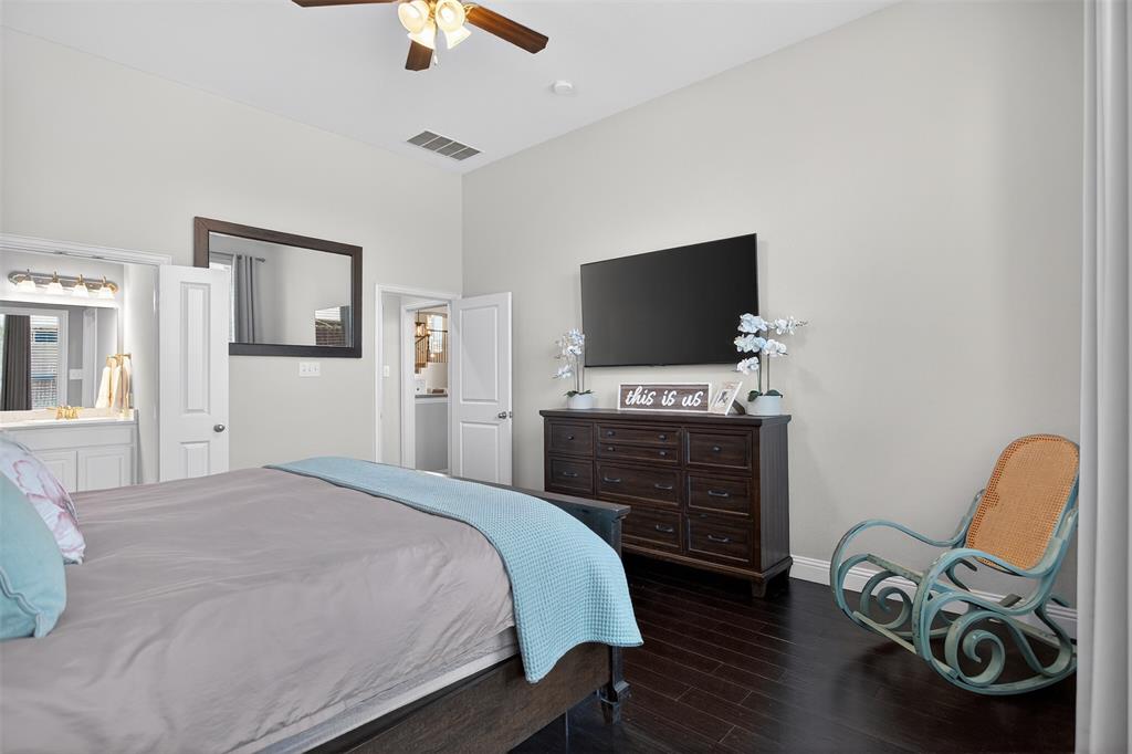 1010 Longhill Way Forney, TX 75126 - Photo 23 of 38 a bedroom with a bed and a flat screen tv