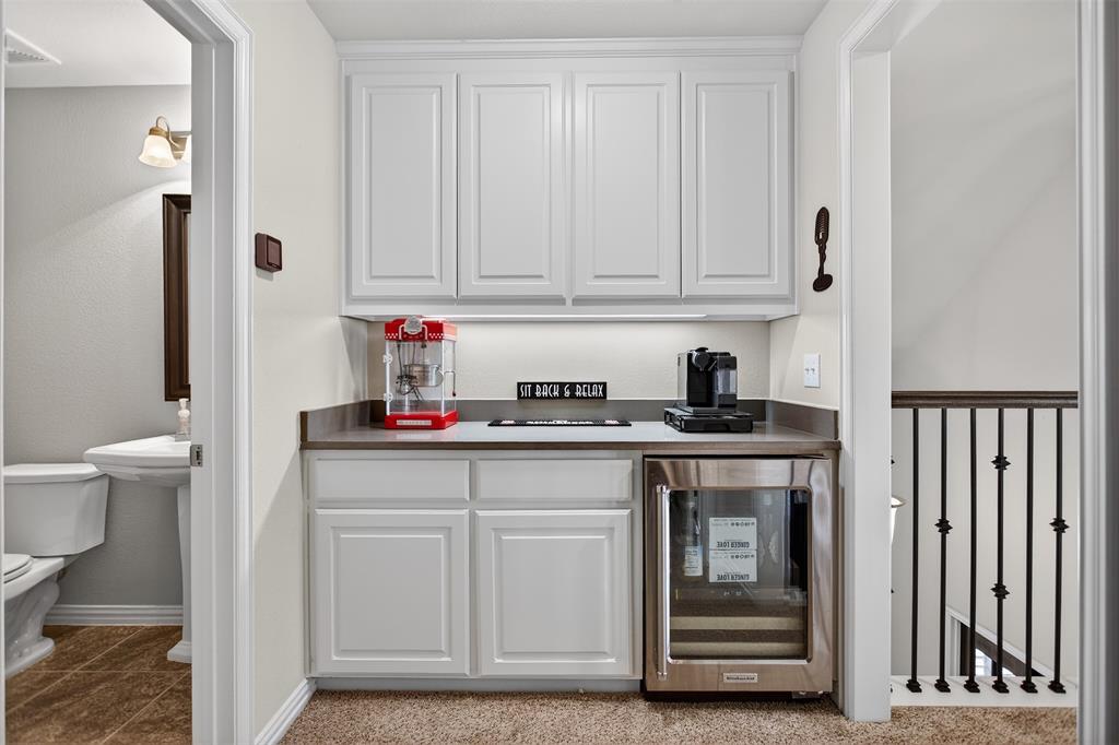1010 Longhill Way Forney, TX 75126 - Photo 27 of 38 a kitchen with white cabinets and sink