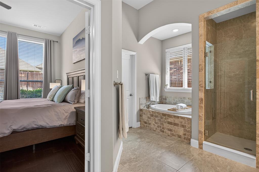 1010 Longhill Way Forney, TX 75126 - Photo 5 of 38 a bedroom with a bed and large windows