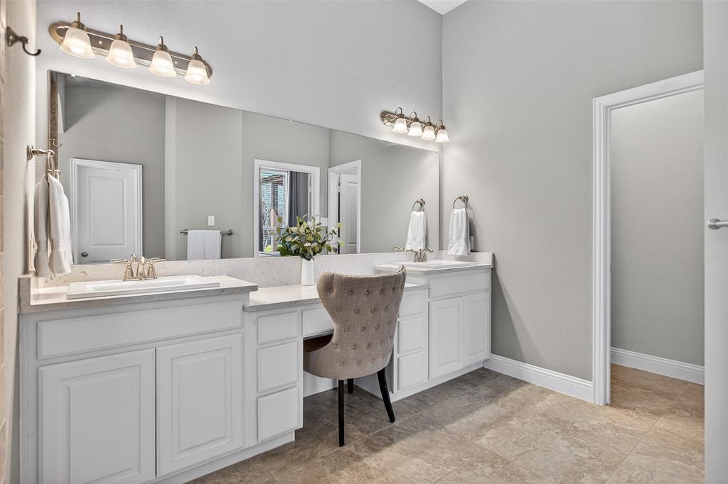 1010 Longhill Way Forney, TX 75126 - Photo 7 of 38 a bathroom with a sink vanity and a mirror