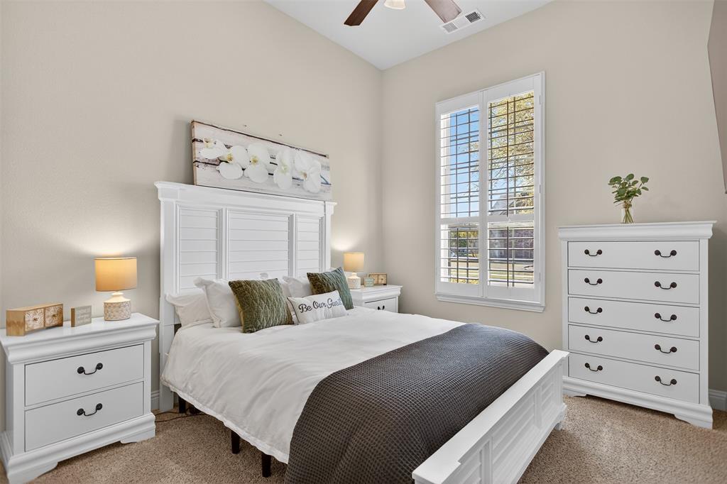 1010 Longhill Way Forney, TX 75126 - Photo 8 of 38 a bedroom with a bed and a dresser