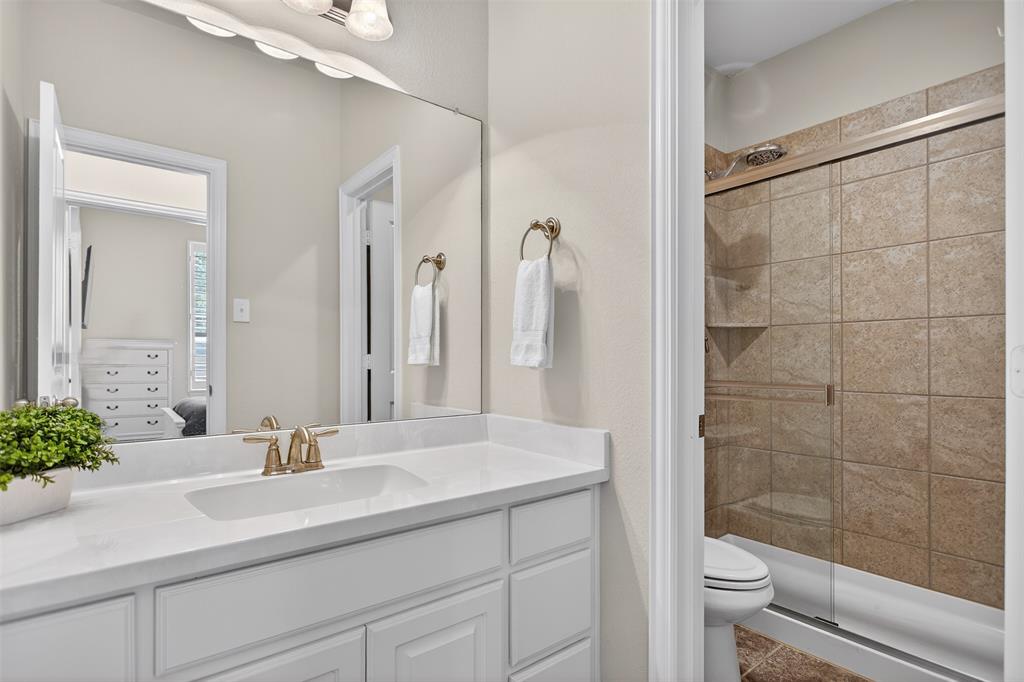 1010 Longhill Way Forney, TX 75126 - Photo 9 of 38 a bathroom with a double vanity sink toilet and shower