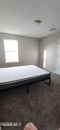 a bedroom with a bed and a night stand