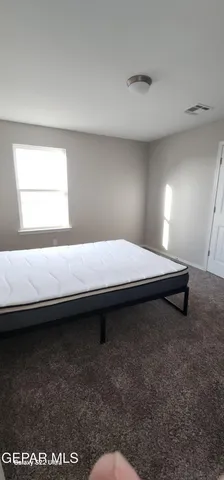 a bedroom with a bed and a night stand