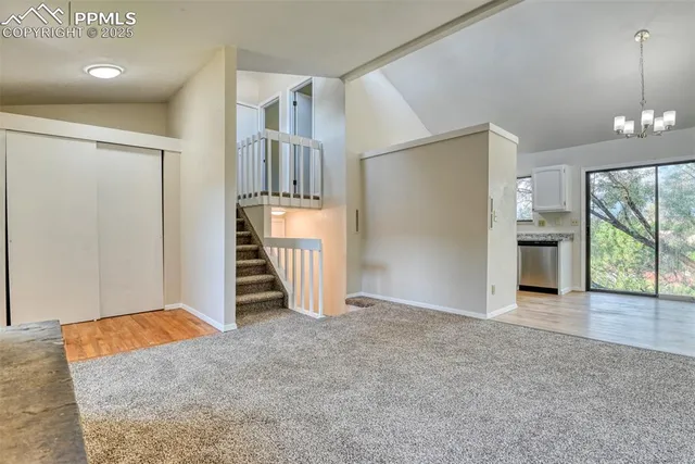 an empty room with a fireplace and entryway