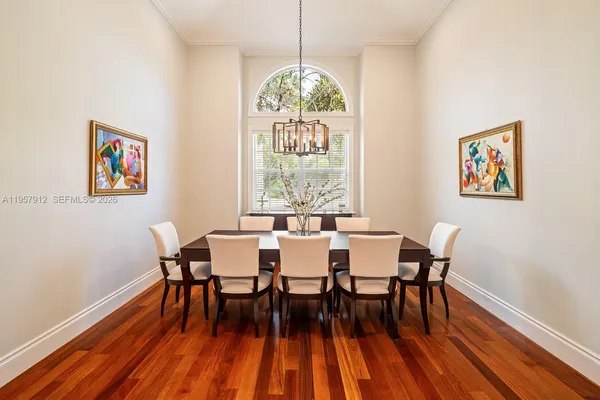 a dining room with furniture a rug and wooden floor
