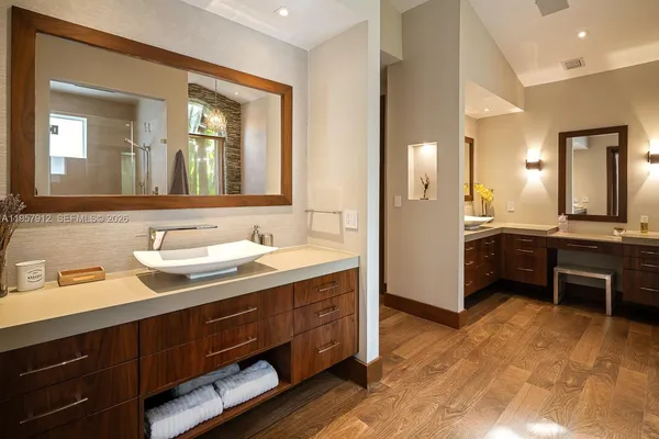 a spacious bathroom with a granite countertop sink and a mirror