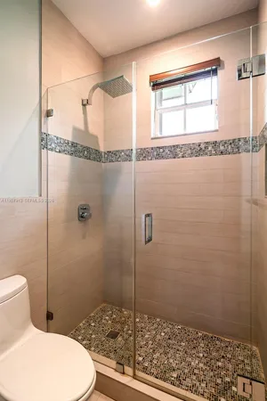 a bathroom with a toilet and a shower