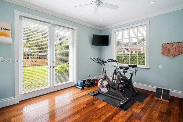 a view of a room with gym equipment and a large window