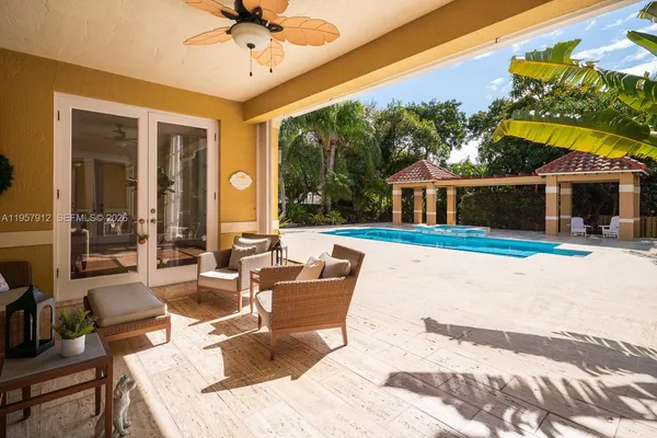 a view of a house with swimming pool and porch