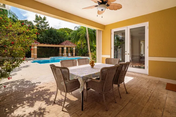 a view of a dining table and chairs in the patio