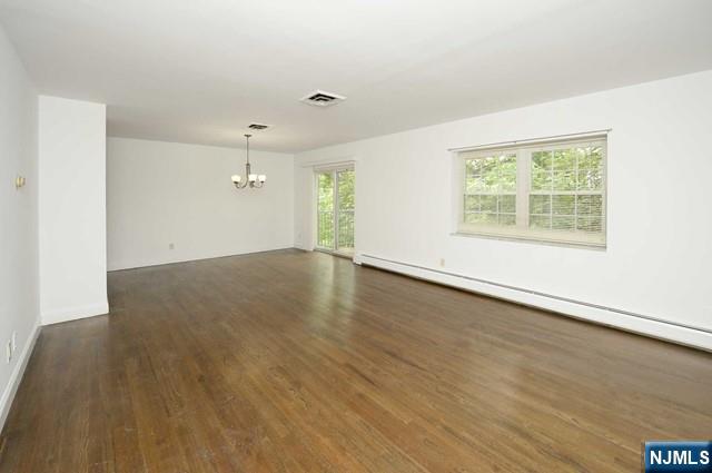 20-30 Ridge Road, Unit A11 Ridgewood, NJ 07450 - Photo 2 of 16 an empty room with wooden floor and windows