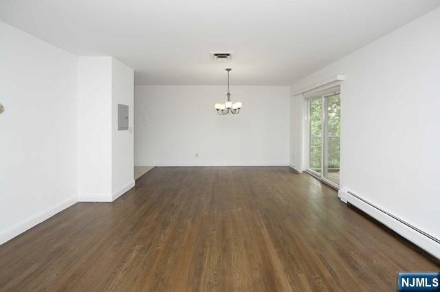 20-30 Ridge Road, Unit A11 Ridgewood, NJ 07450 - Photo 3 of 16 an empty room with wooden floor ceiling fan and windows