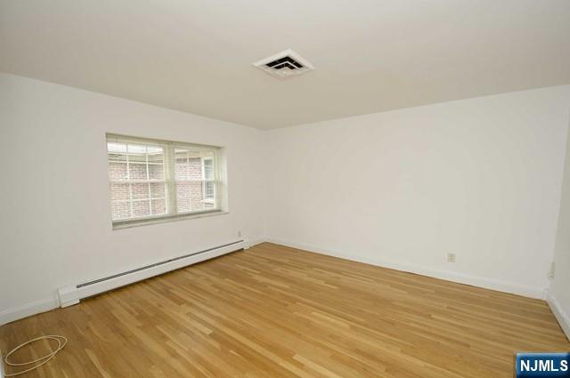 20-30 Ridge Road, Unit A11 Ridgewood, NJ 07450 - Photo 8 of 16 a view of an empty room with wooden floor and a window