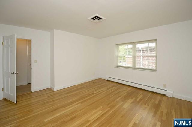 20-30 Ridge Road, Unit A11 Ridgewood, NJ 07450 - Photo 9 of 16 a view of an empty room with wooden floor and a window