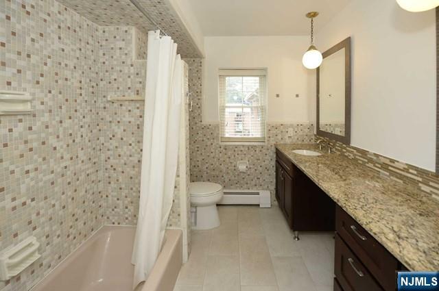 20-30 Ridge Road, Unit A11 Ridgewood, NJ 07450 - Photo 10 of 16 a bathroom with a granite countertop sink a toilet and a bathtub