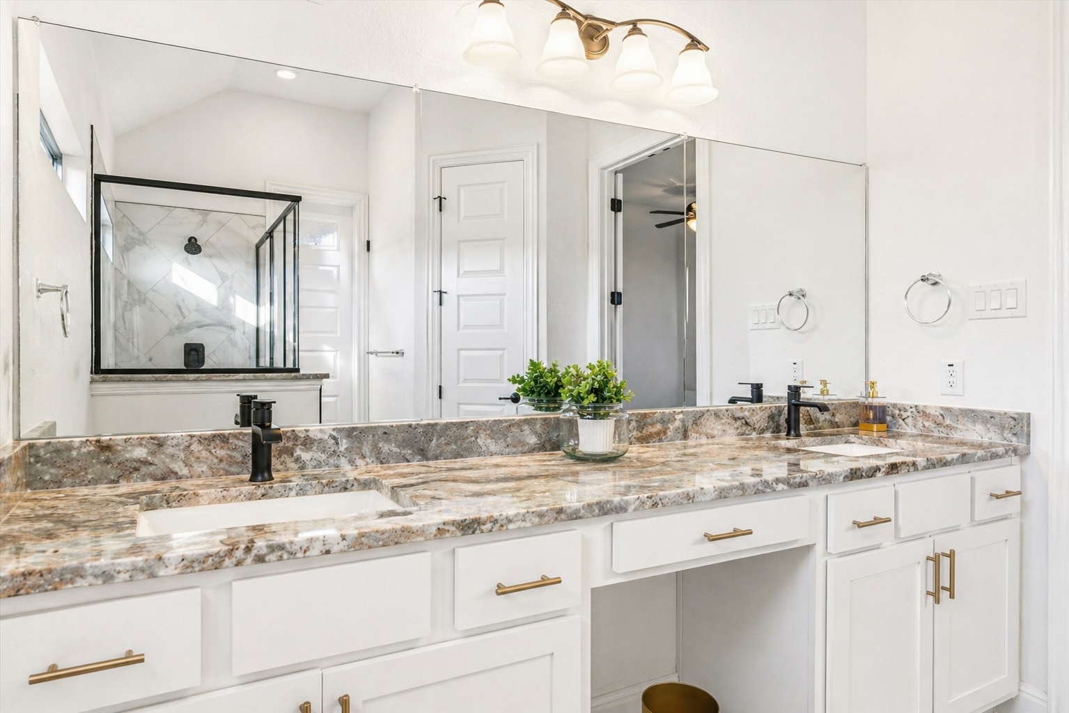 209 Rainier Drive Kyle, TX 78640 - Photo 5 of 24 Dual vanity with undermount sinks, Marble countertop, matte black faucets, and white cabinetry with brass hardware