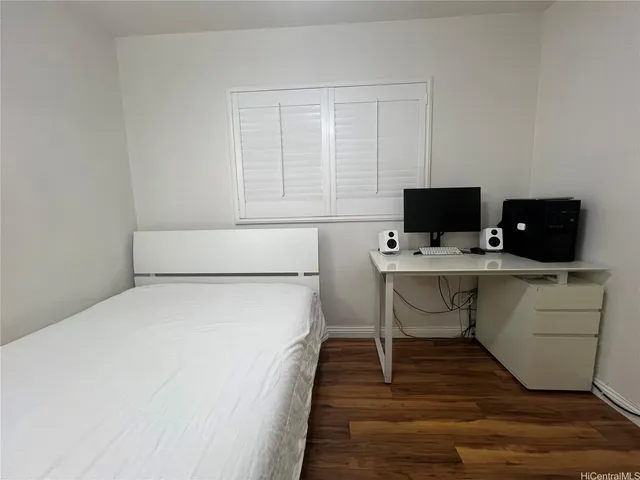 a view of a workspace with furniture and wooden floor