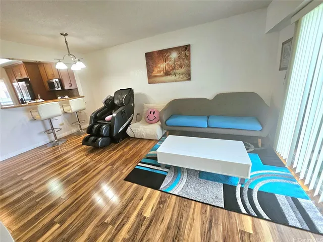 a living room with furniture rug and wooden floor