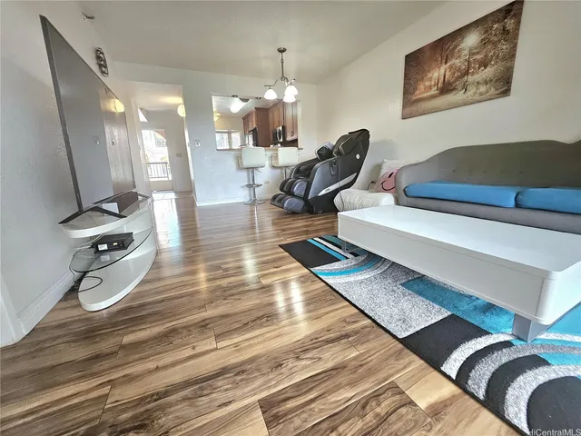a living room with furniture a rug and white walls