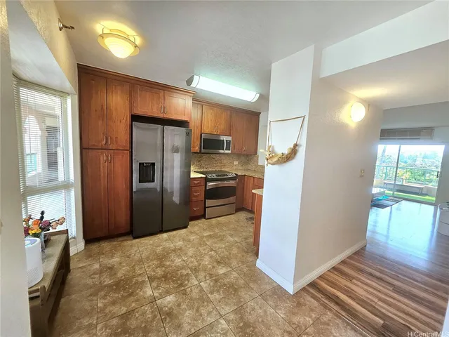 a kitchen with granite countertop a refrigerator and a sink