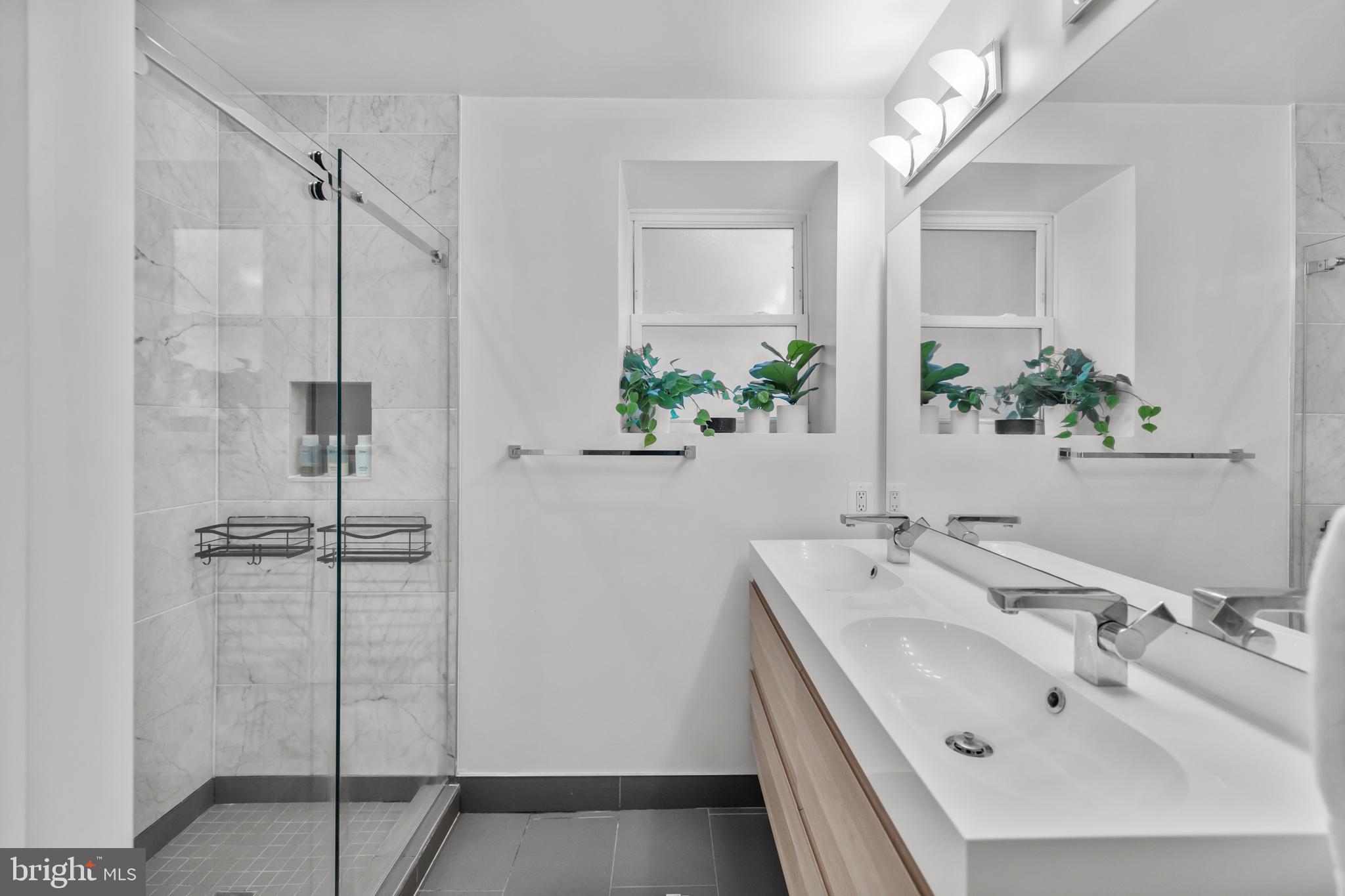 1324 W Street Northwest, Unit 1 Washington, DC 20009 - Photo 23 of 37 a bathroom with a sink and shower