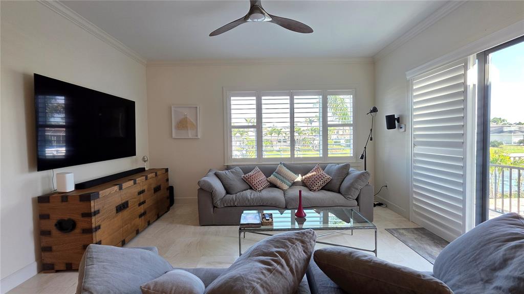 531 Birdie Lane Longboat Key, FL 34228 - Photo 13 of 43 a living room with furniture and a flat screen tv
