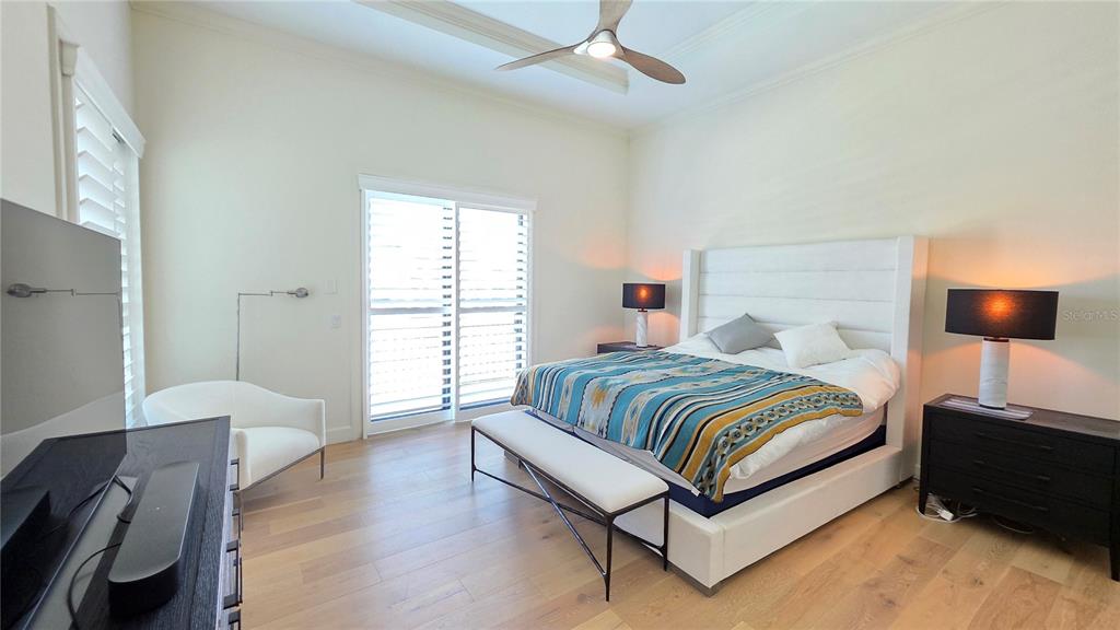 531 Birdie Lane Longboat Key, FL 34228 - Photo 17 of 43 a spacious bedroom with a bed and wooden floor