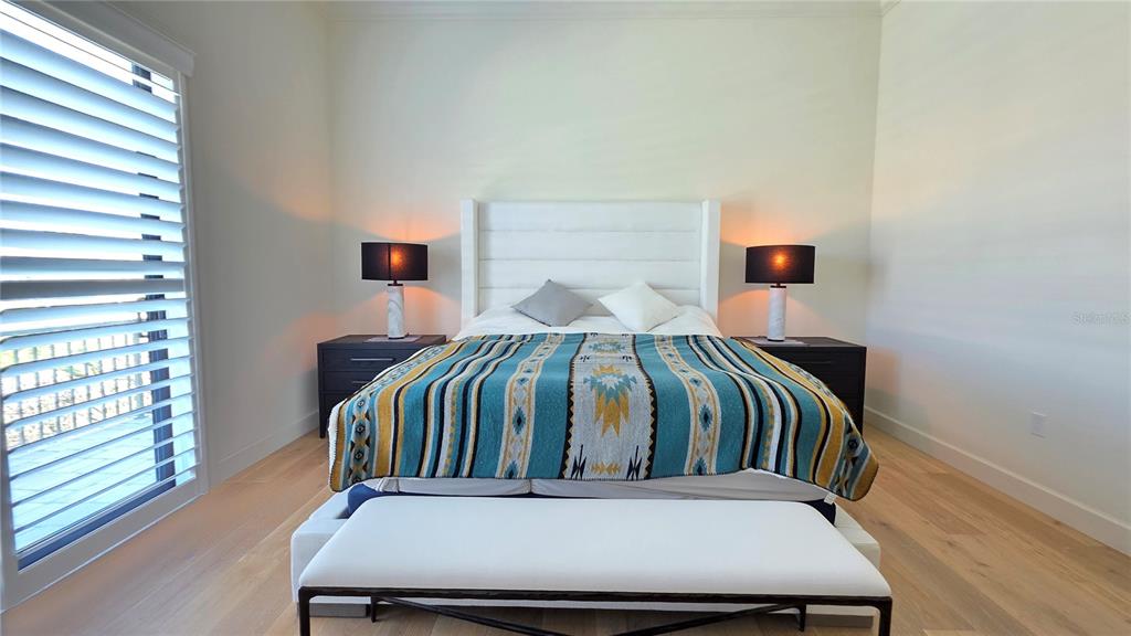 531 Birdie Lane Longboat Key, FL 34228 - Photo 18 of 43 a bedroom with a bed and a window