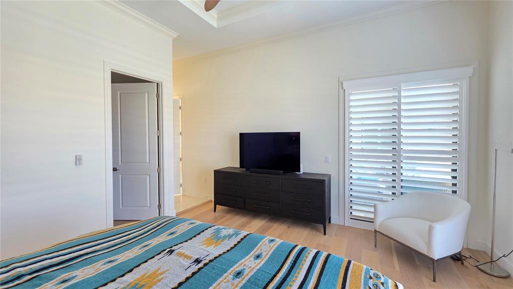 531 Birdie Lane Longboat Key, FL 34228 - Photo 19 of 43 a bedroom with furniture and a window