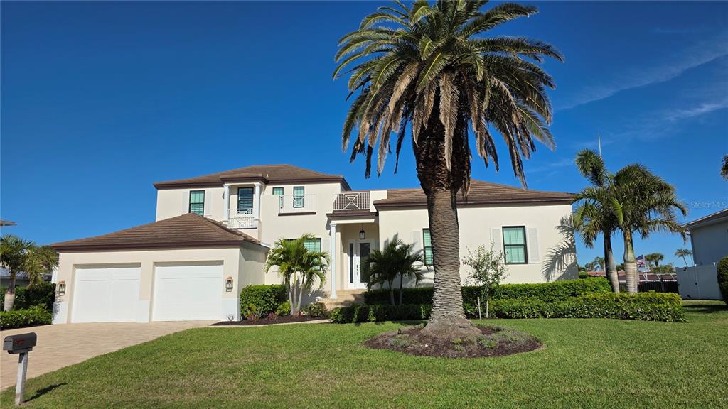 531 Birdie Lane Longboat Key, FL 34228 - Photo 2 of 43 a front view of house with yard and green space