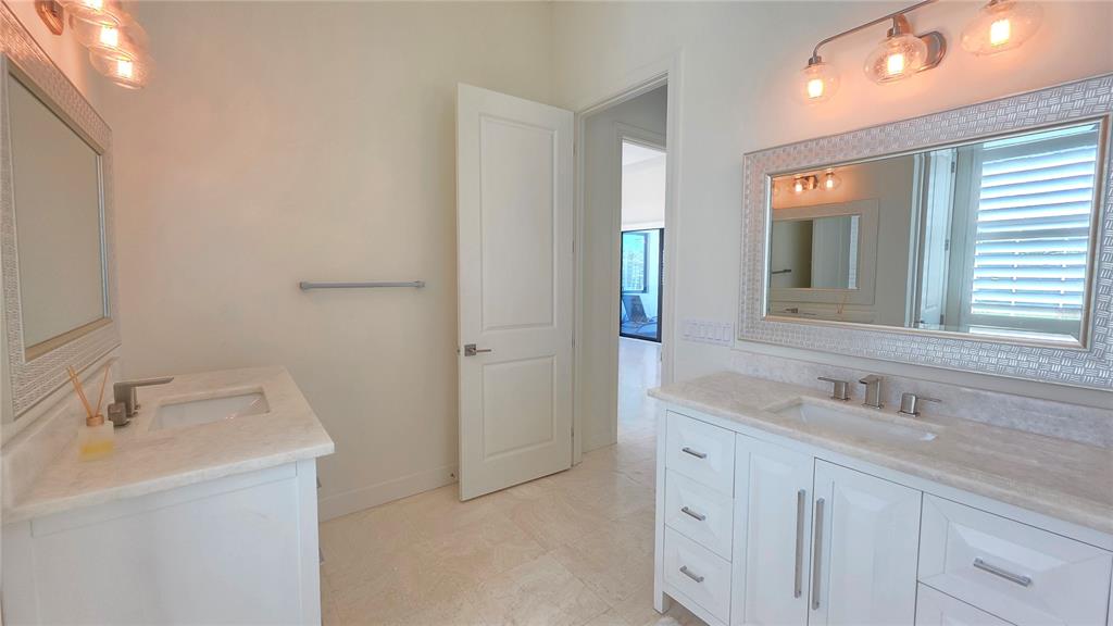 531 Birdie Lane Longboat Key, FL 34228 - Photo 22 of 43 a bathroom with a sink and a mirror
