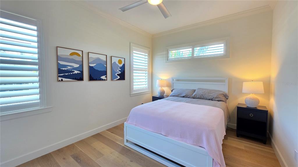 531 Birdie Lane Longboat Key, FL 34228 - Photo 27 of 43 a bedroom with a bed and a window
